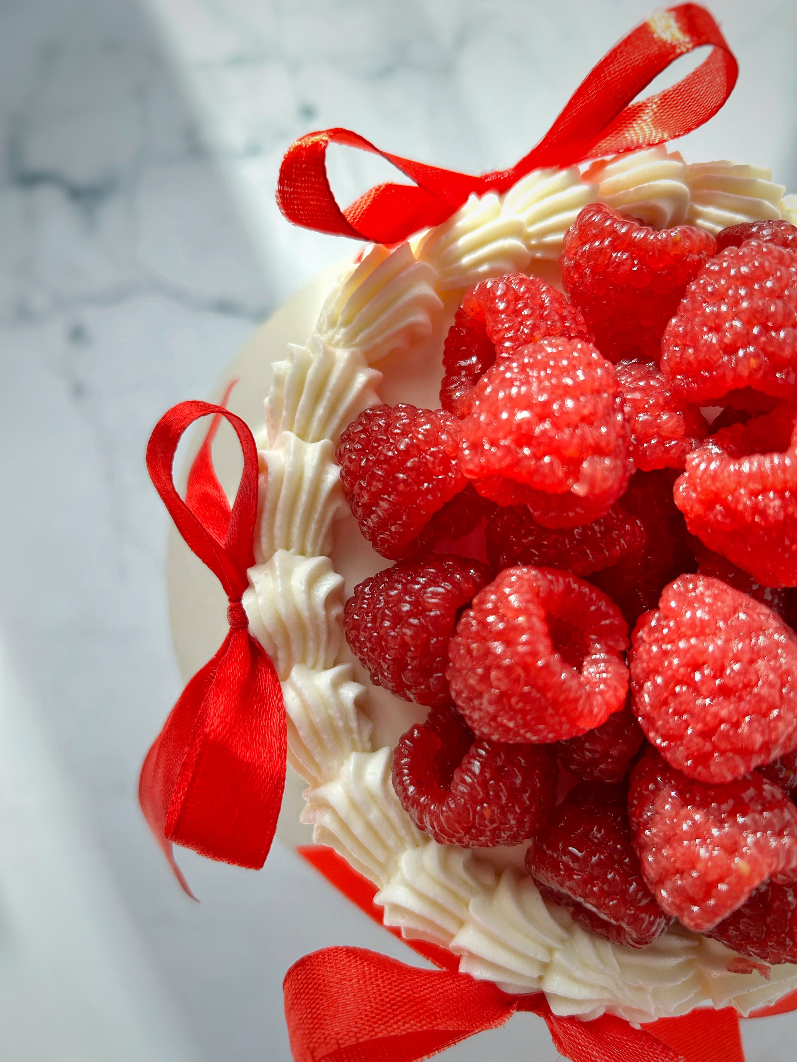 Raspberry Cake with Whipped Cream and Red Ribbons · Free Stock Photo
