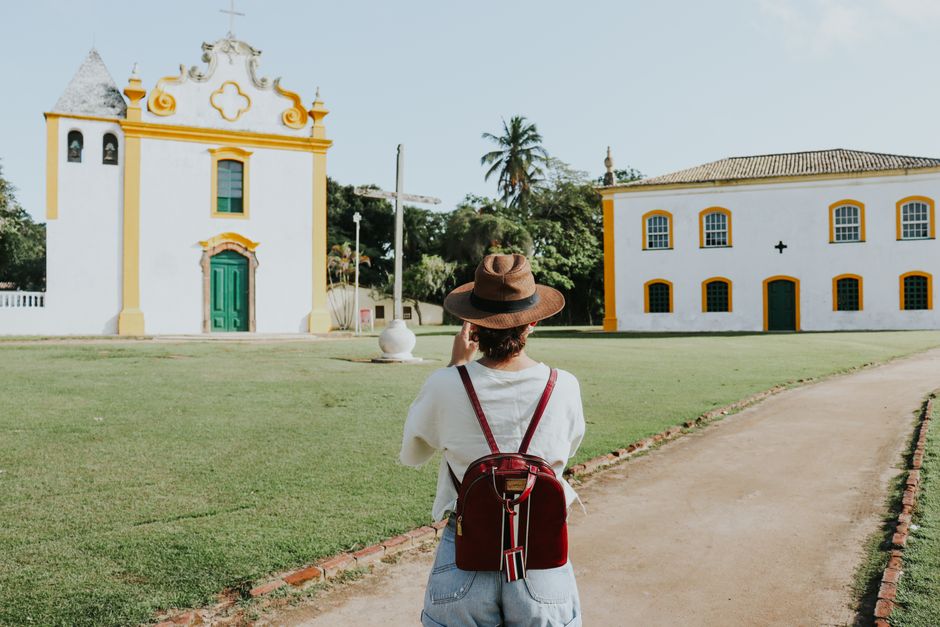 Traveler taking photos of a historic church in Porto Seguro, Bahia, Brazil.