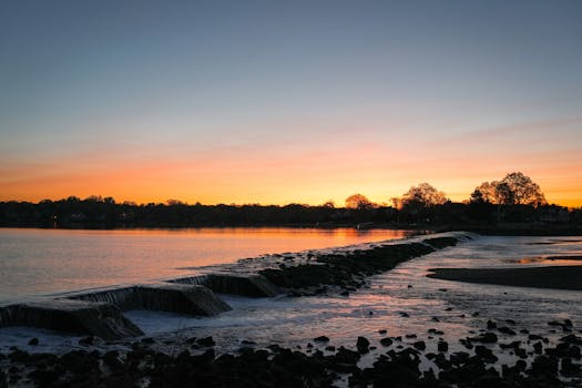 Capture the tranquil beauty of a sunrise over waterfalls at Cove Island Park, Stamford, Connecticut.