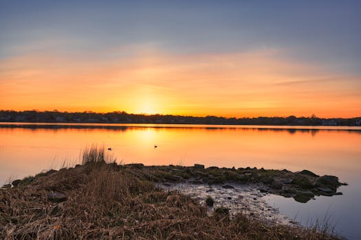 Beautiful sunrise reflecting on calm waters at Cove Island Park, Stamford, Connecticut.