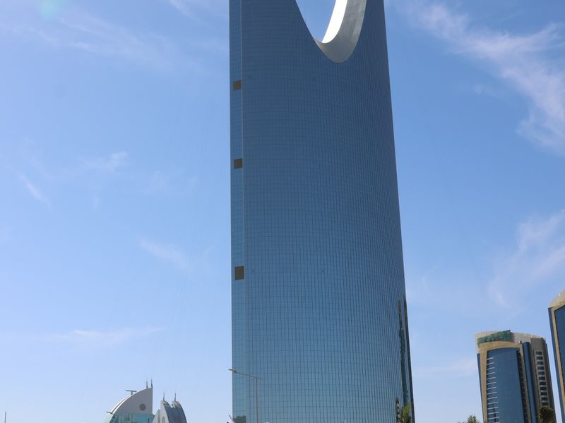 Kingdom Centre tower with its sky bridge across the top against a blue sky