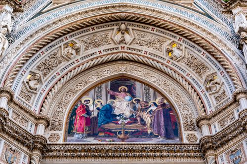 Free Close-up of Florence Cathedral's ornate facade showcasing religious frescoes and sculptures in Tuscany, Italy. Stock Photo