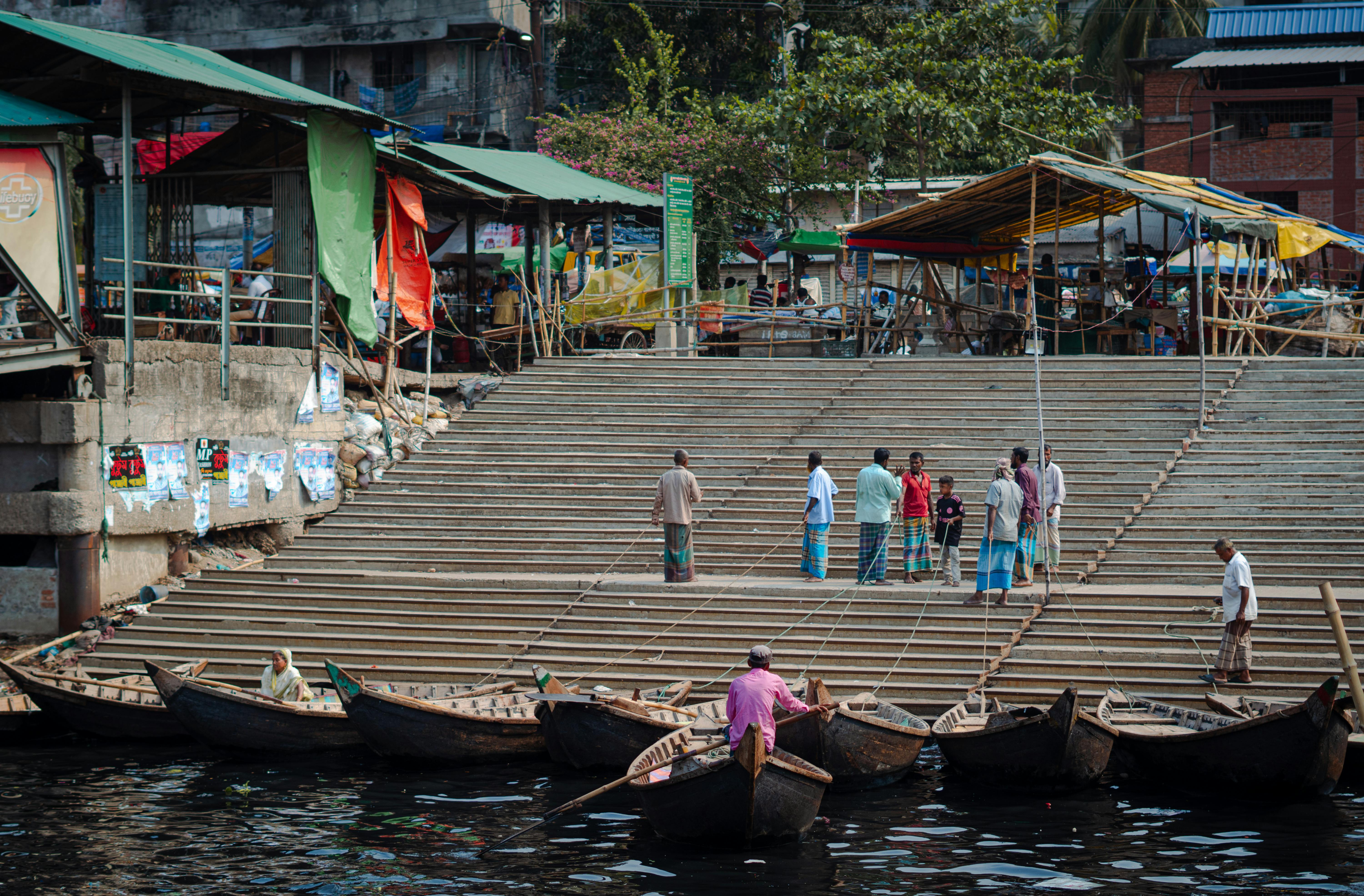 Busy riverbank market scene, representing local business activity.