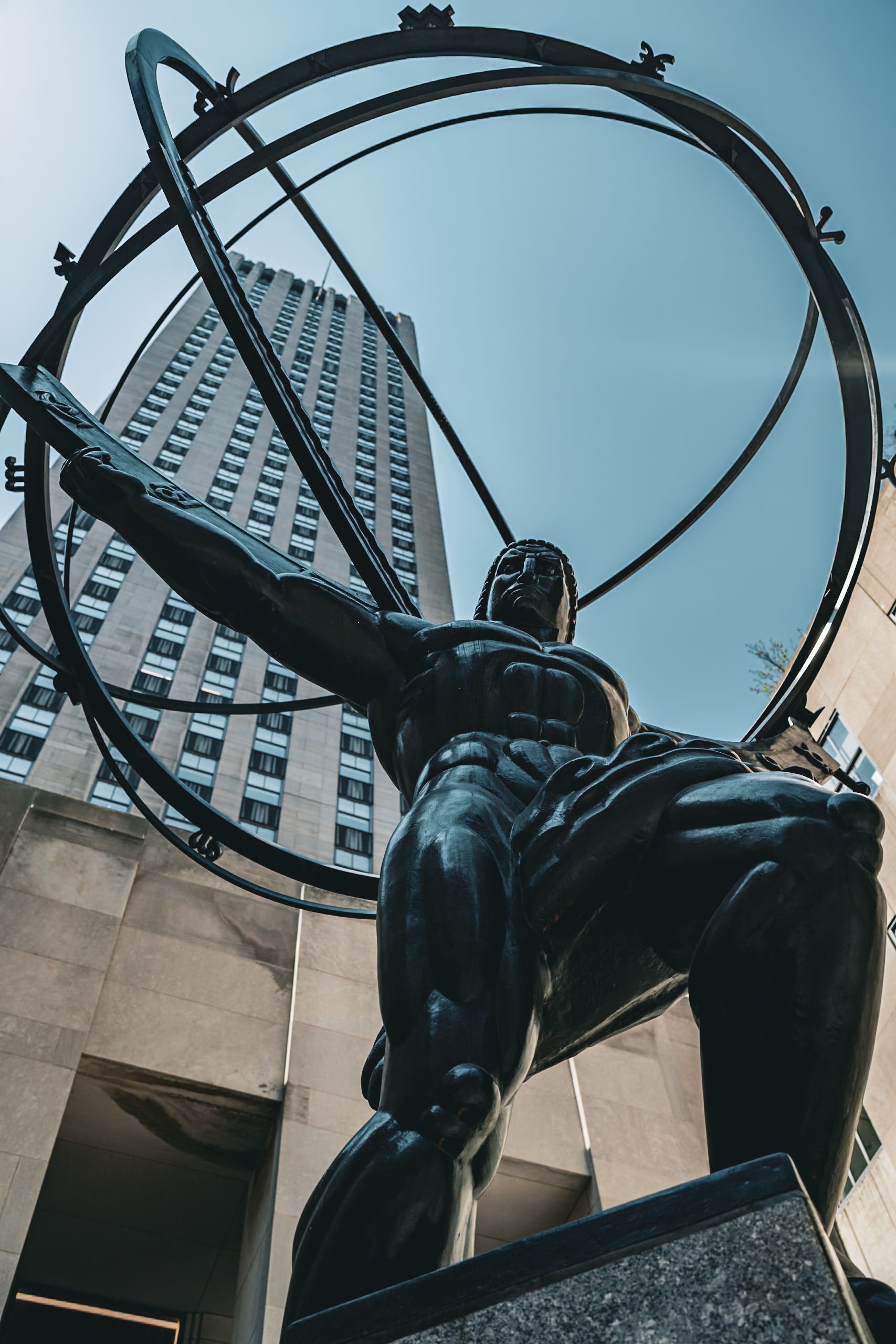 Iconic Atlas statue in front of Rockefeller Center in New York City, symbolizing strength and endurance.