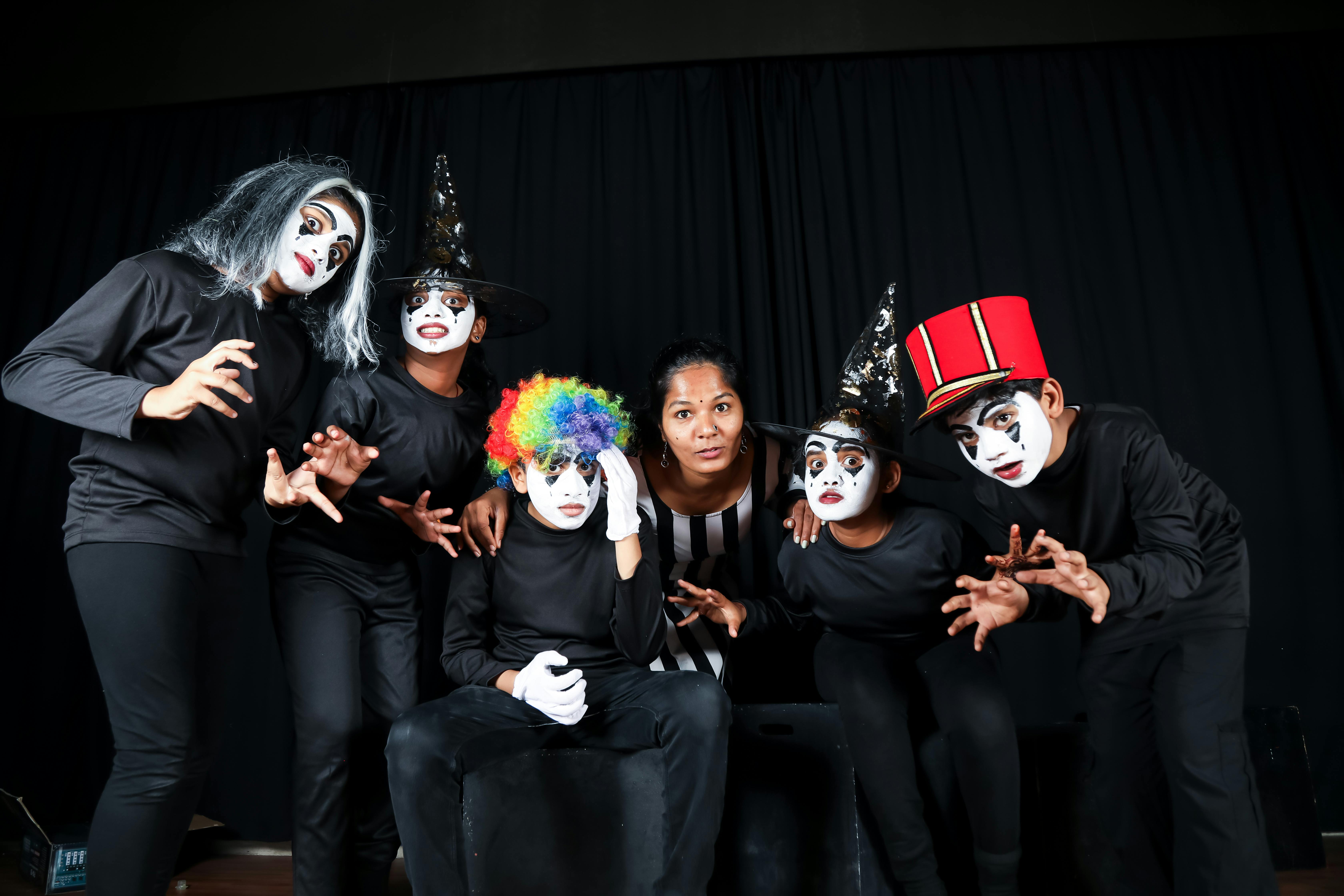 Free A group of mime artists pose in colorful costumes during a theatrical performance. Stock Photo