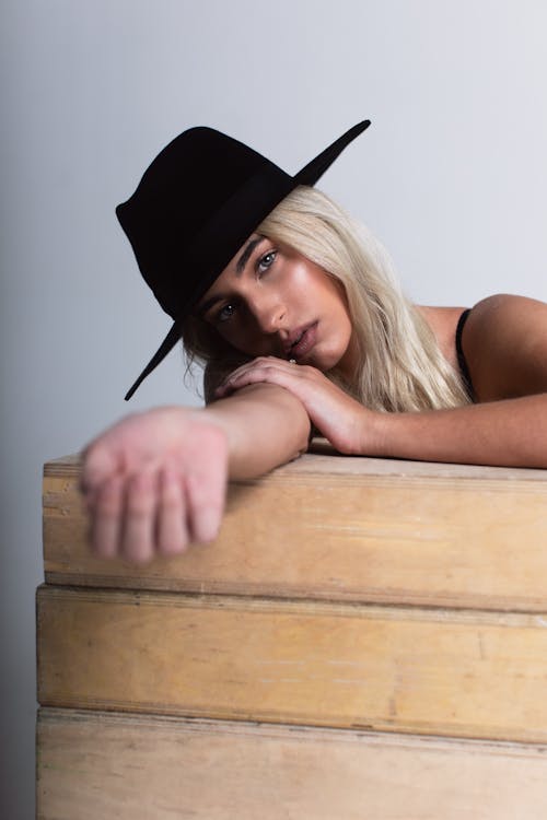 Photo Of Woman Leaning On Wooden Surface