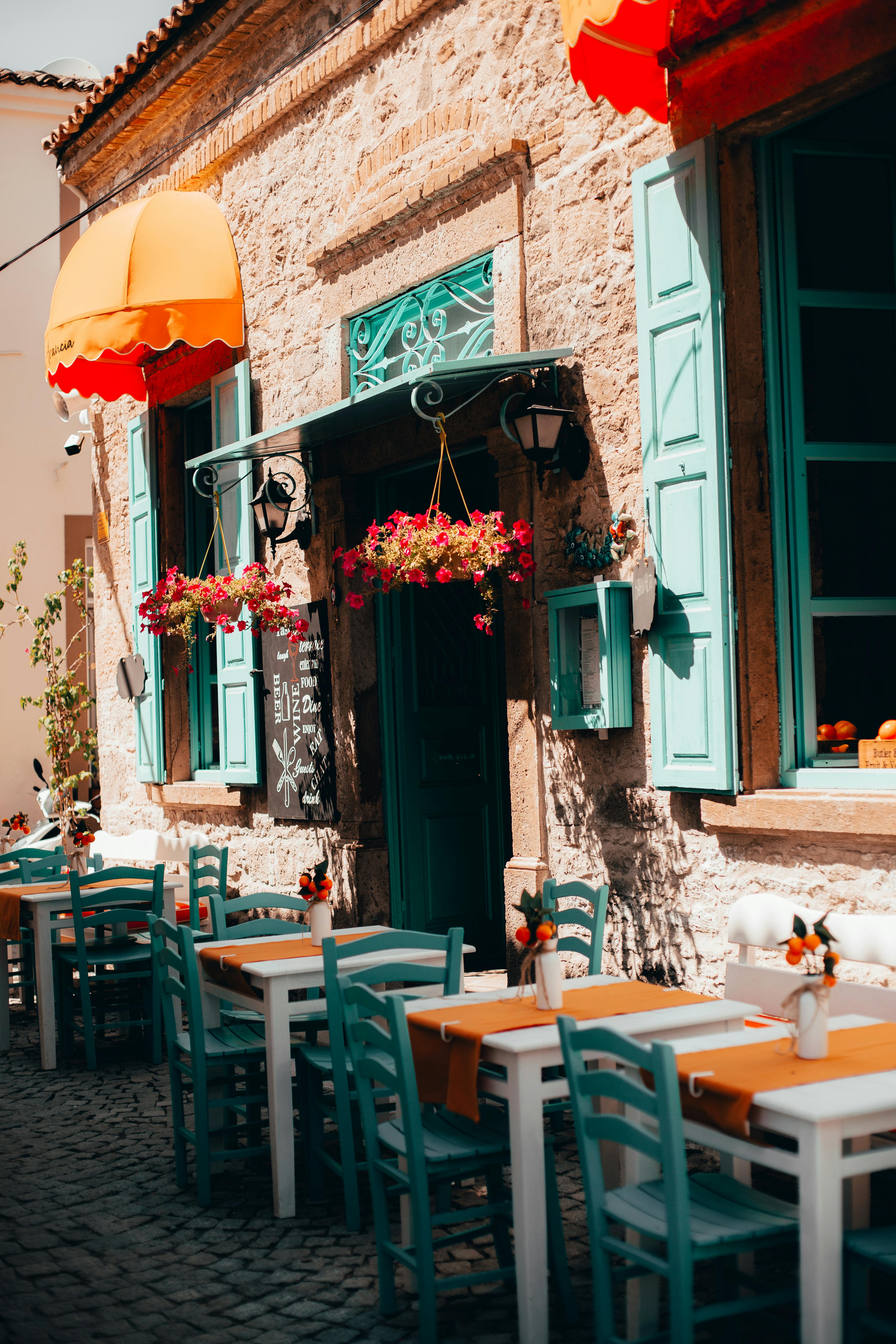 White Tables With Blue Chairs In An Empty Alfresco Area Of A Restaurant