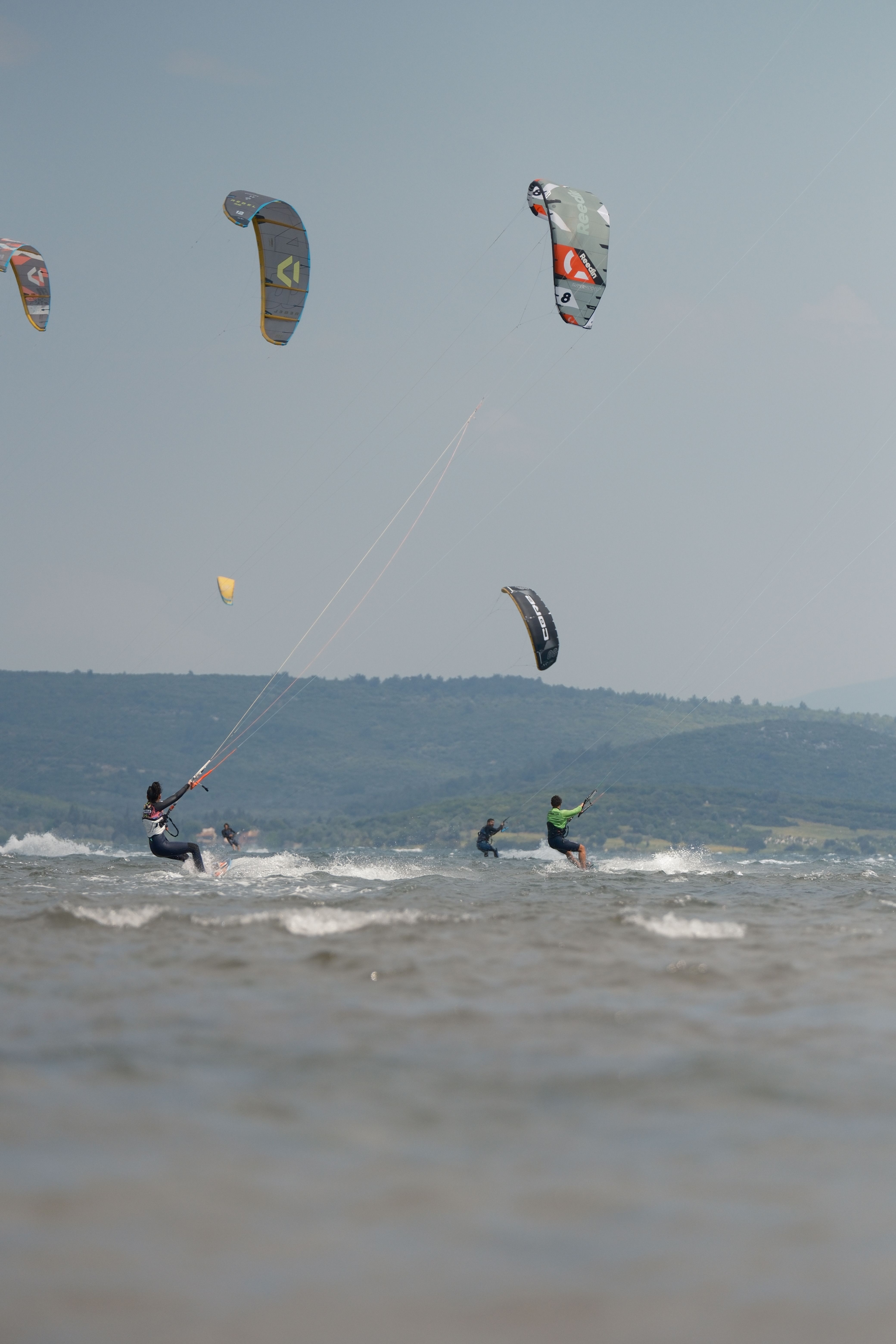 Kitesurfing Enthusiasts Ride Waves Outdoors · Free Stock Photo
