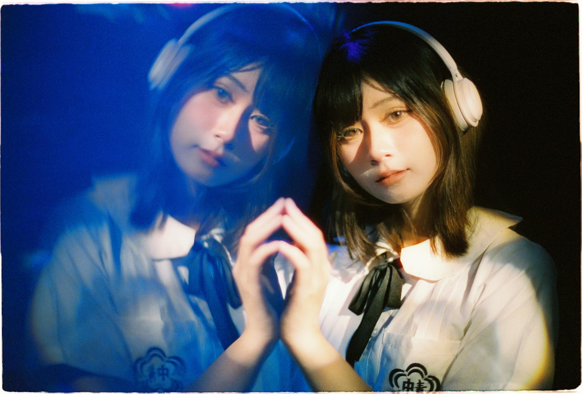 Artistic portrait of a girl with headphones, showing a reflective and serene expression.