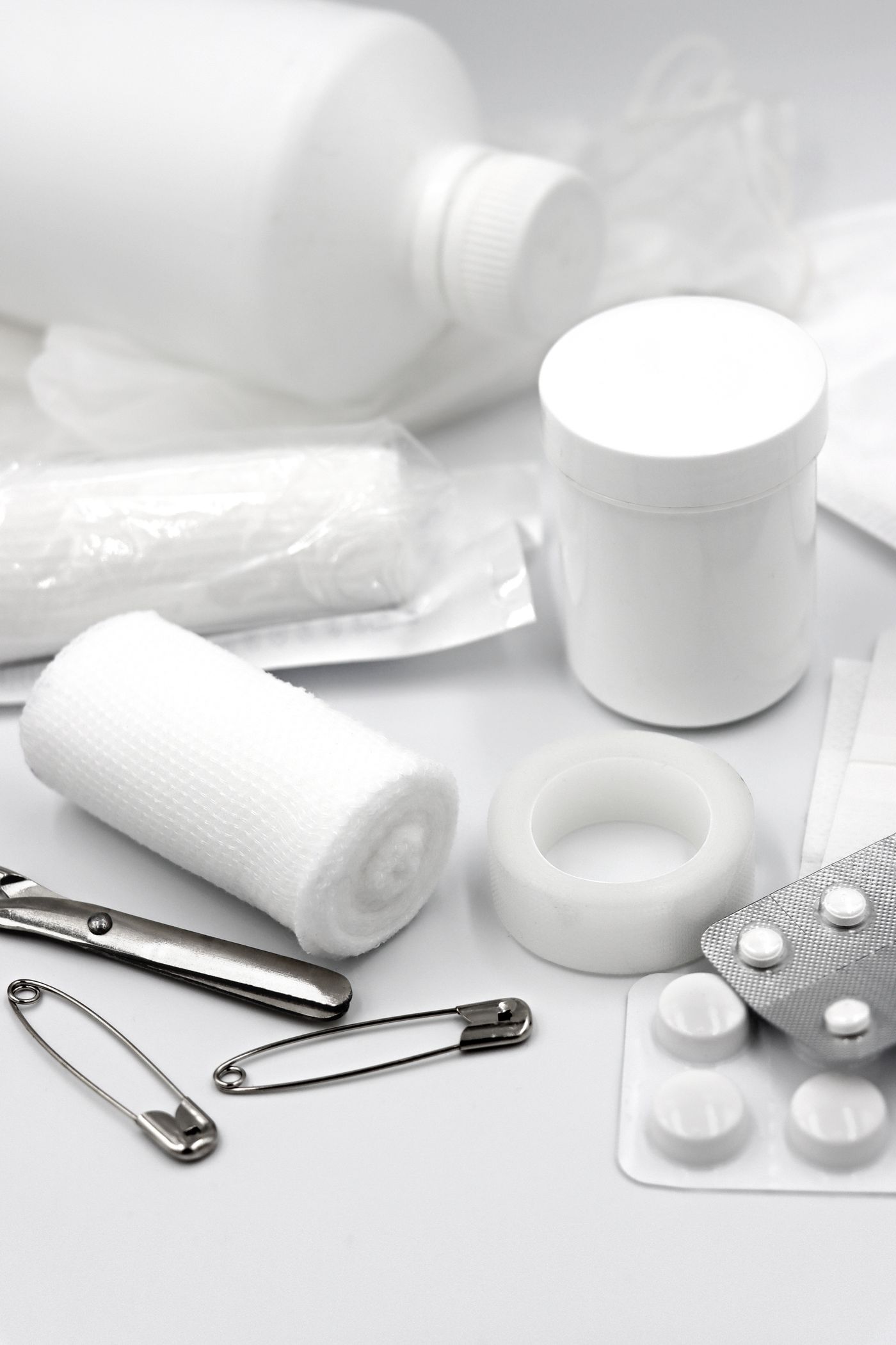 Flat lay of first aid supplies including bandages, gauze, tape, and scissors