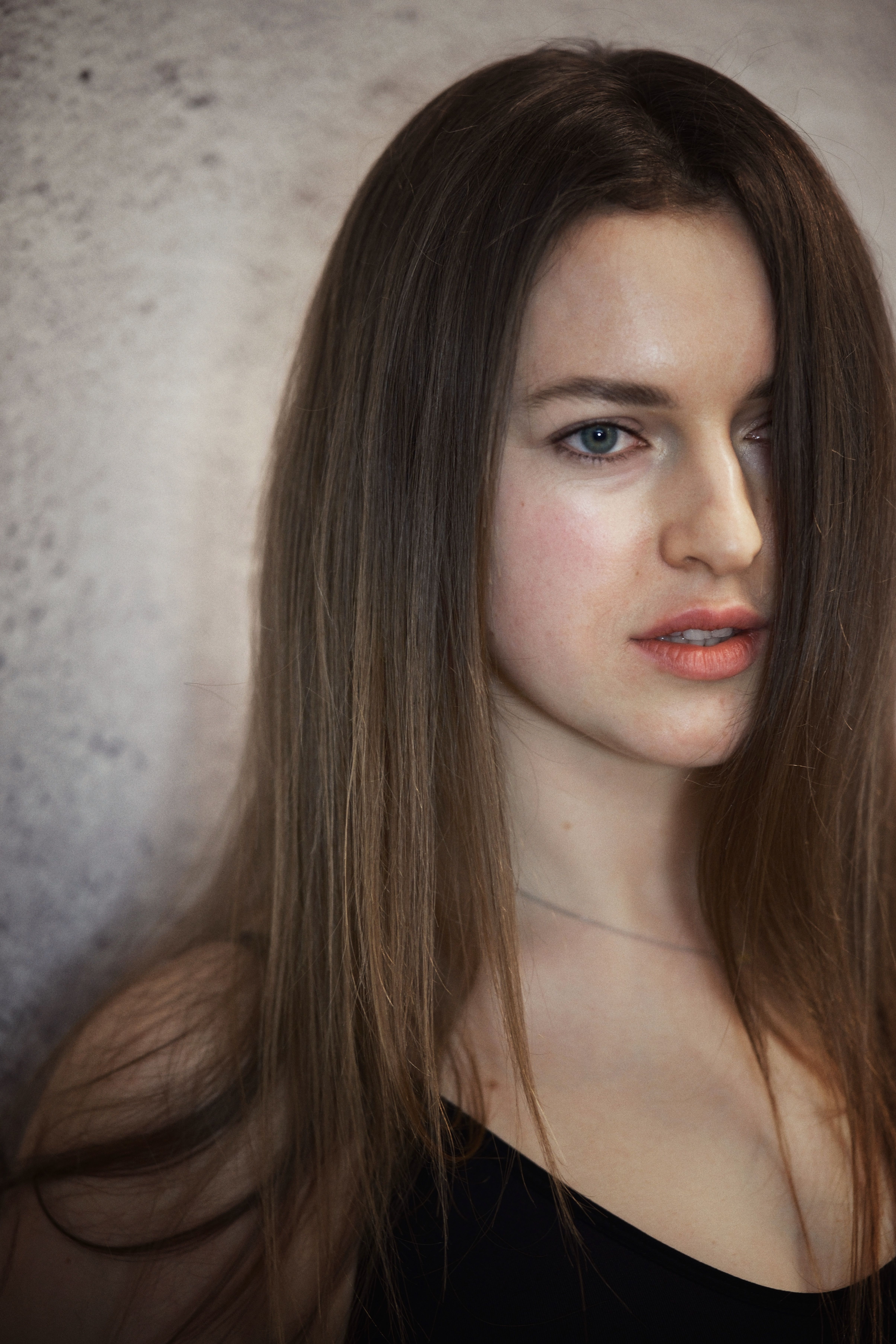 Close-up portrait of a young woman with natural beauty, soft lighting.