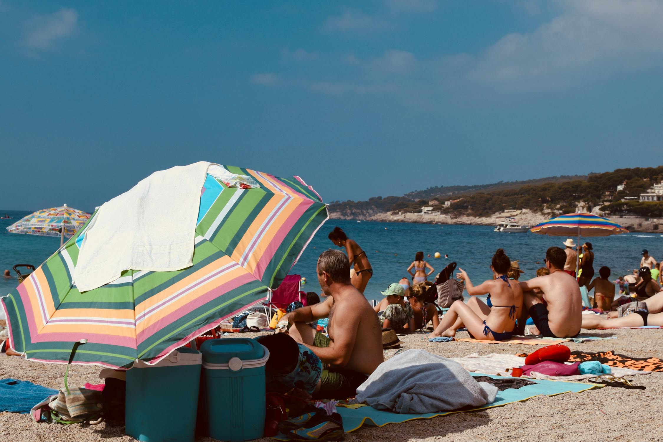People sitting on the sand during daytime at a beach in French Riviera