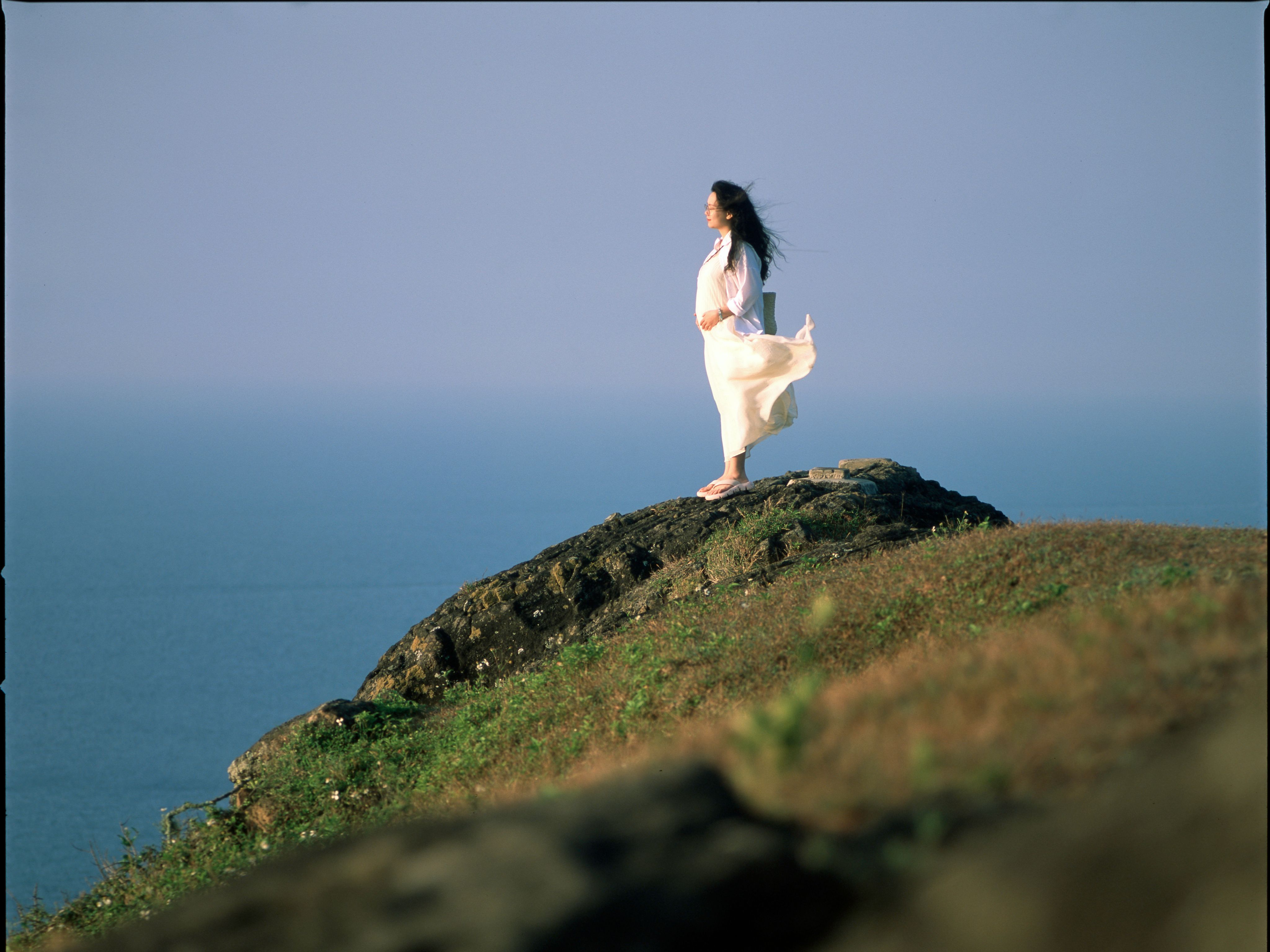 Woman in White Dress Standing on Ocean Cliff · Free Stock Photo