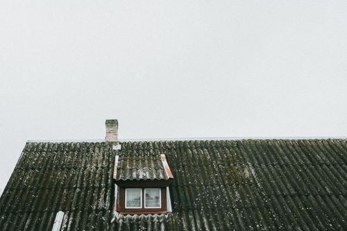 Free A vintage roof with a small window and chimney in Poland, showcasing old architectural charm. Stock Photo