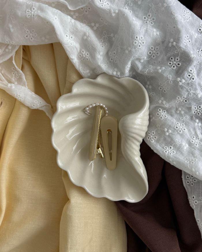 Hair clips arranged in a shell dish
