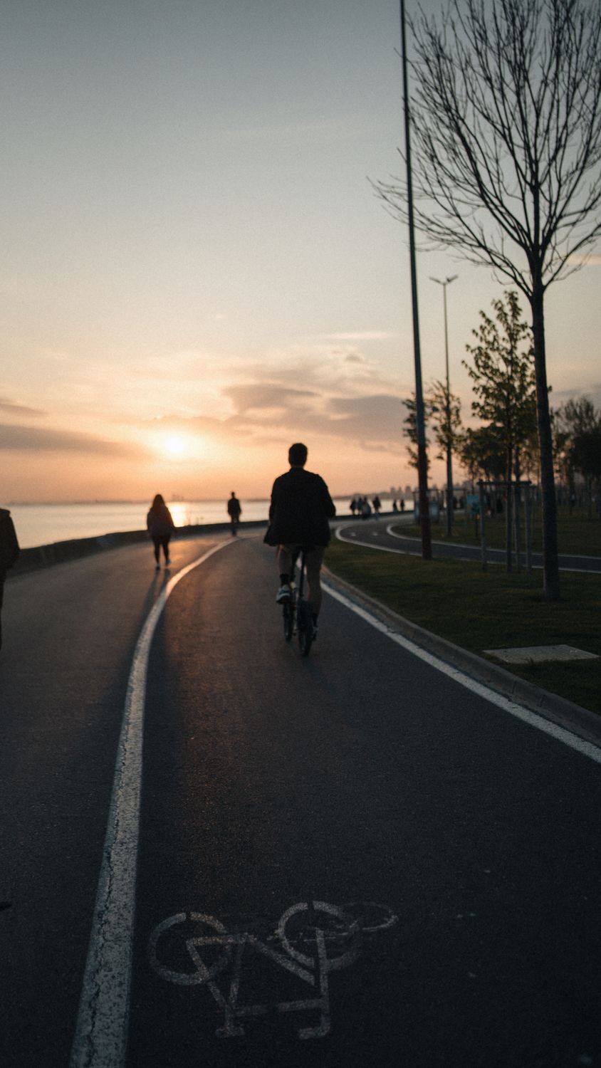 Scenic Sunset Bike Ride Along a Waterfront Β· Free Stock Photo