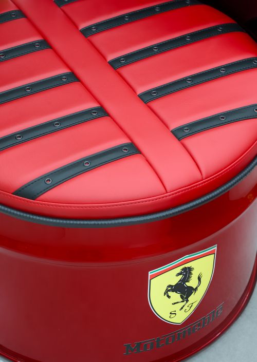 Free Elegant red leather seat featuring black accents and iconic logo detail. Stock Photo
