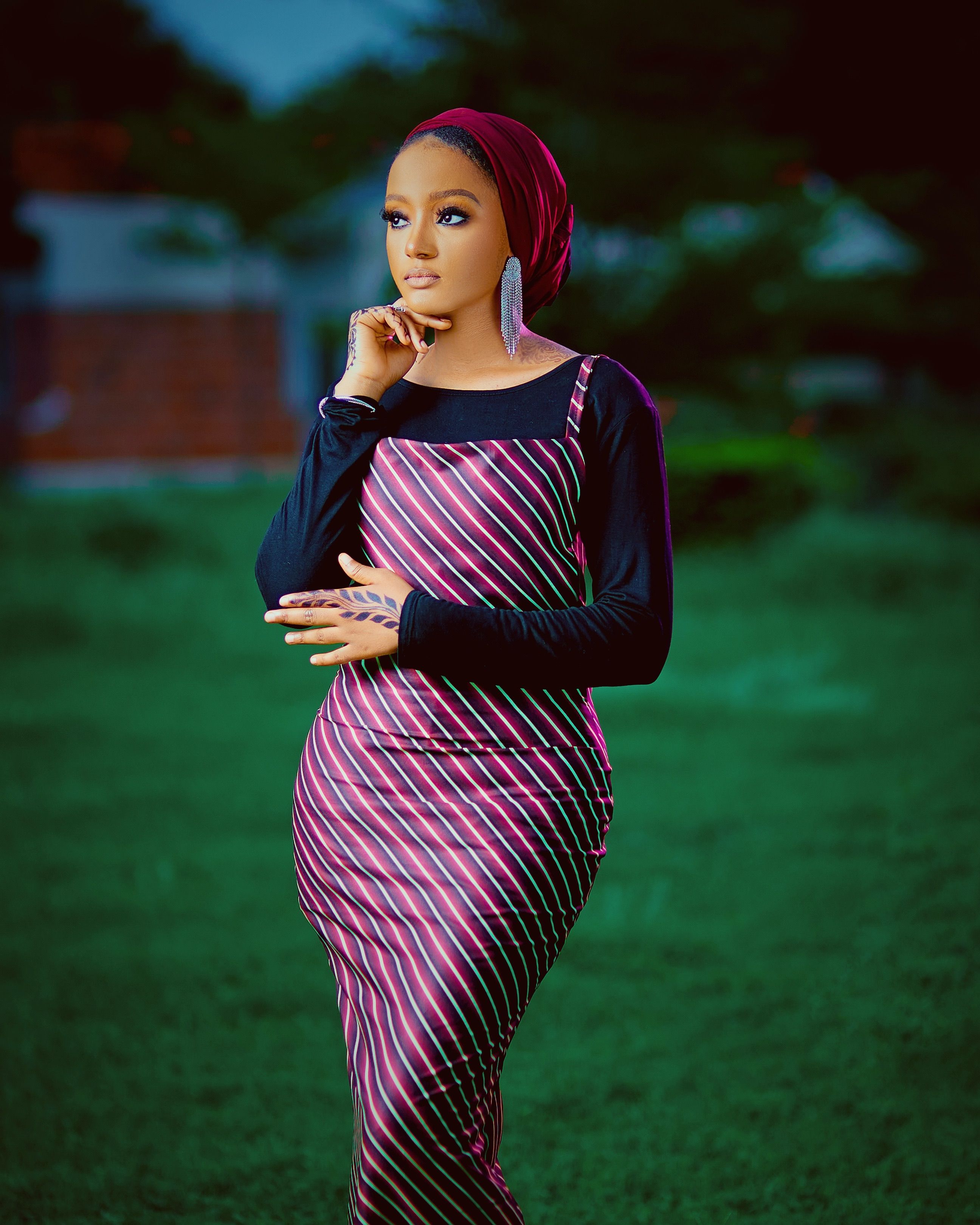 Elegant Woman in Striped Dress Outdoors · Free Stock Photo