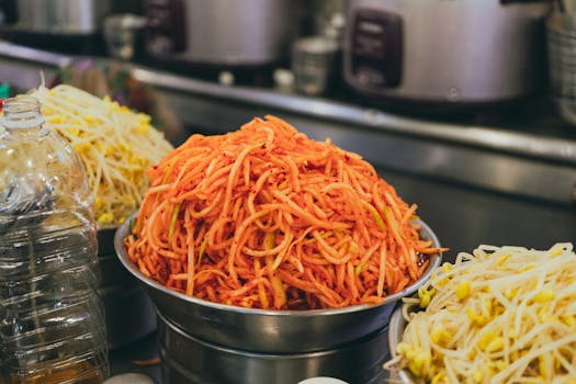 Delicious variety of Korean street food noodles displayed in a vibrant market setting in Seoul.