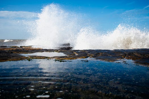 Powerful ocean waves crash against rocky shoreline in Mar del Plata, Argentina.