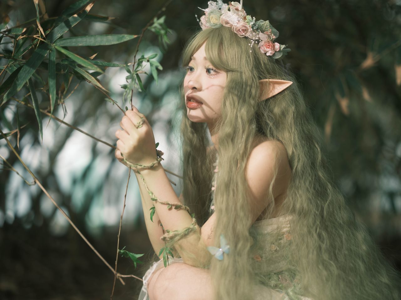 a magical portrait of an elf with a flower crown in a lush forest embo