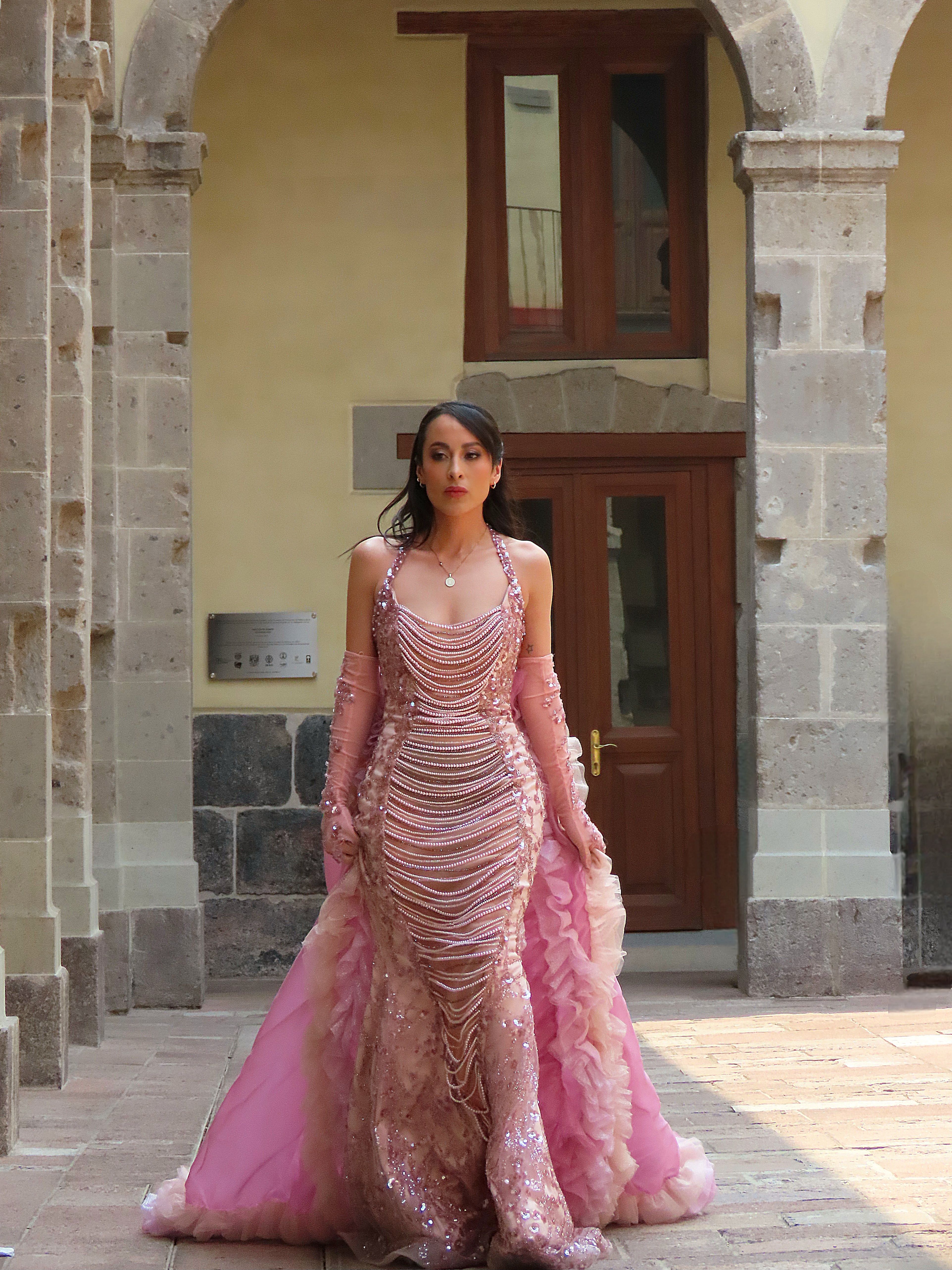 Elegant Woman in Pink Gown at Historic Building