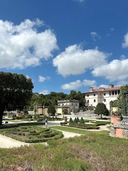 Beautiful Italianate garden featuring historic architecture under a vibrant blue sky.