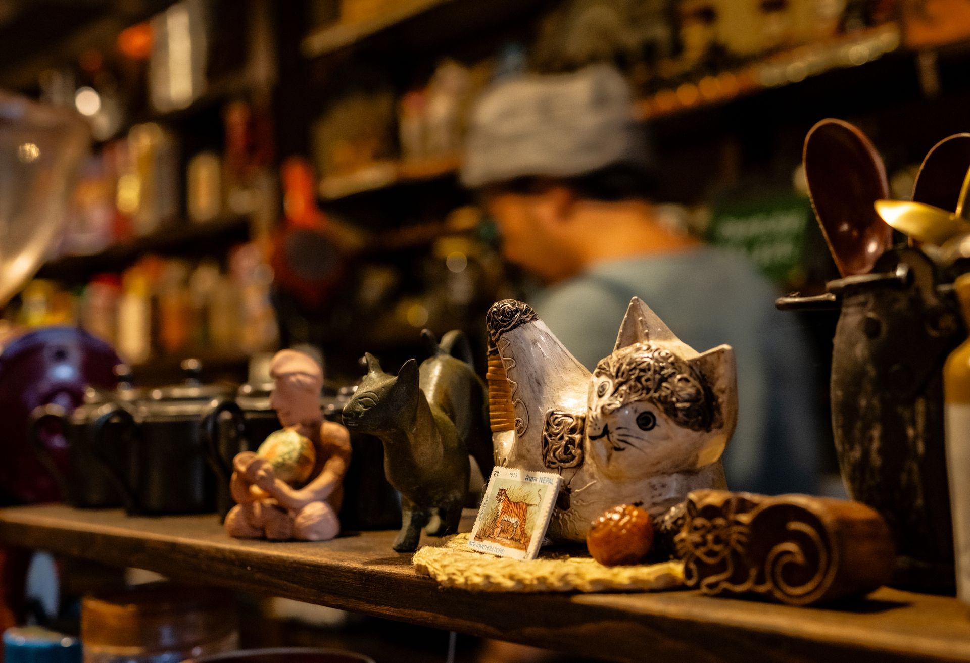 A cozy Japanese shop with eclectic ceramic figures and pots, capturing authentic culture.