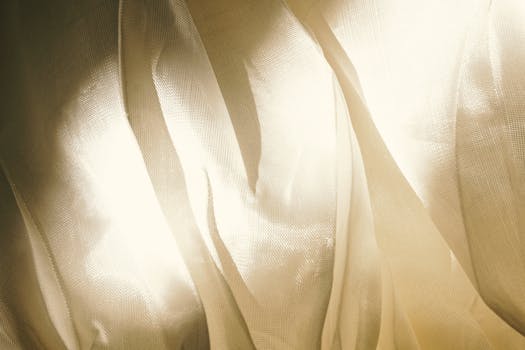 Elegant interplay of light and fabric texture creating an abstract visual.