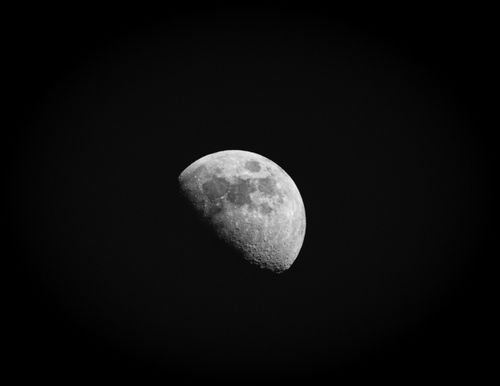 Free Captivating black and white photograph of the half moon showcasing detailed craters. Stock Photo