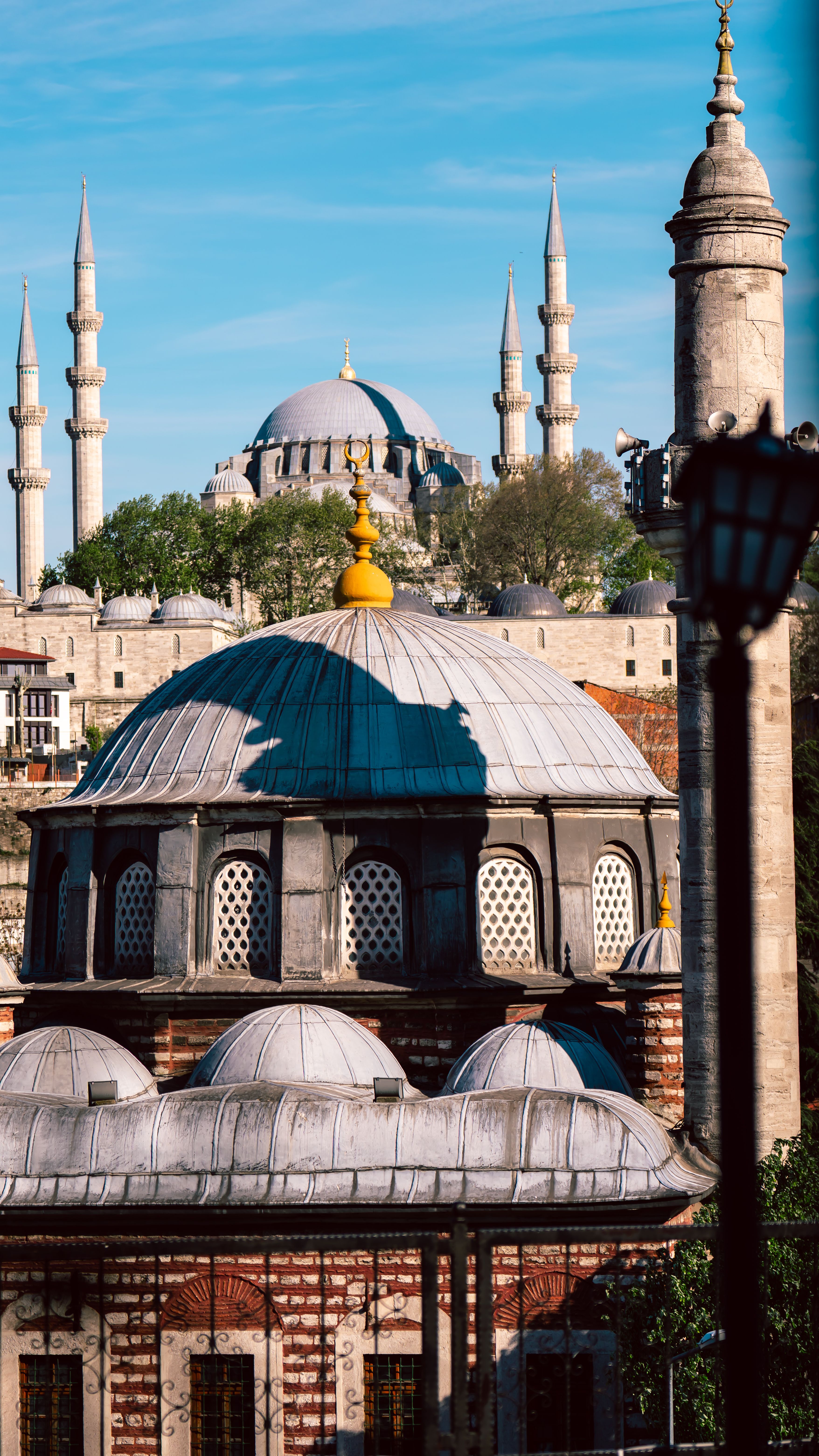 View of the iconic Süleymaniye Mosque with Istanbul's historic skyline under a clear blue sky.