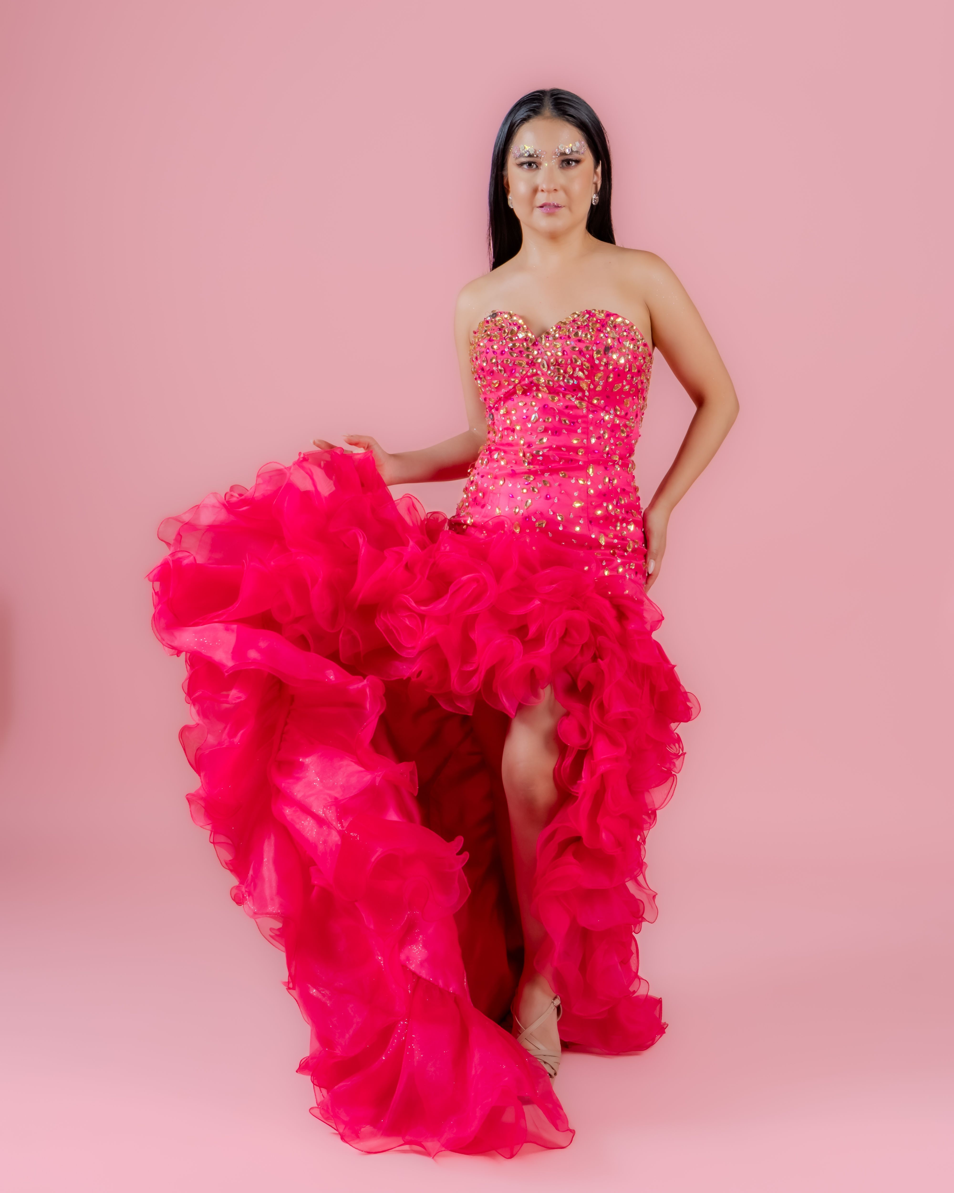 Elegant Woman in Pink Dress on Pink Background
