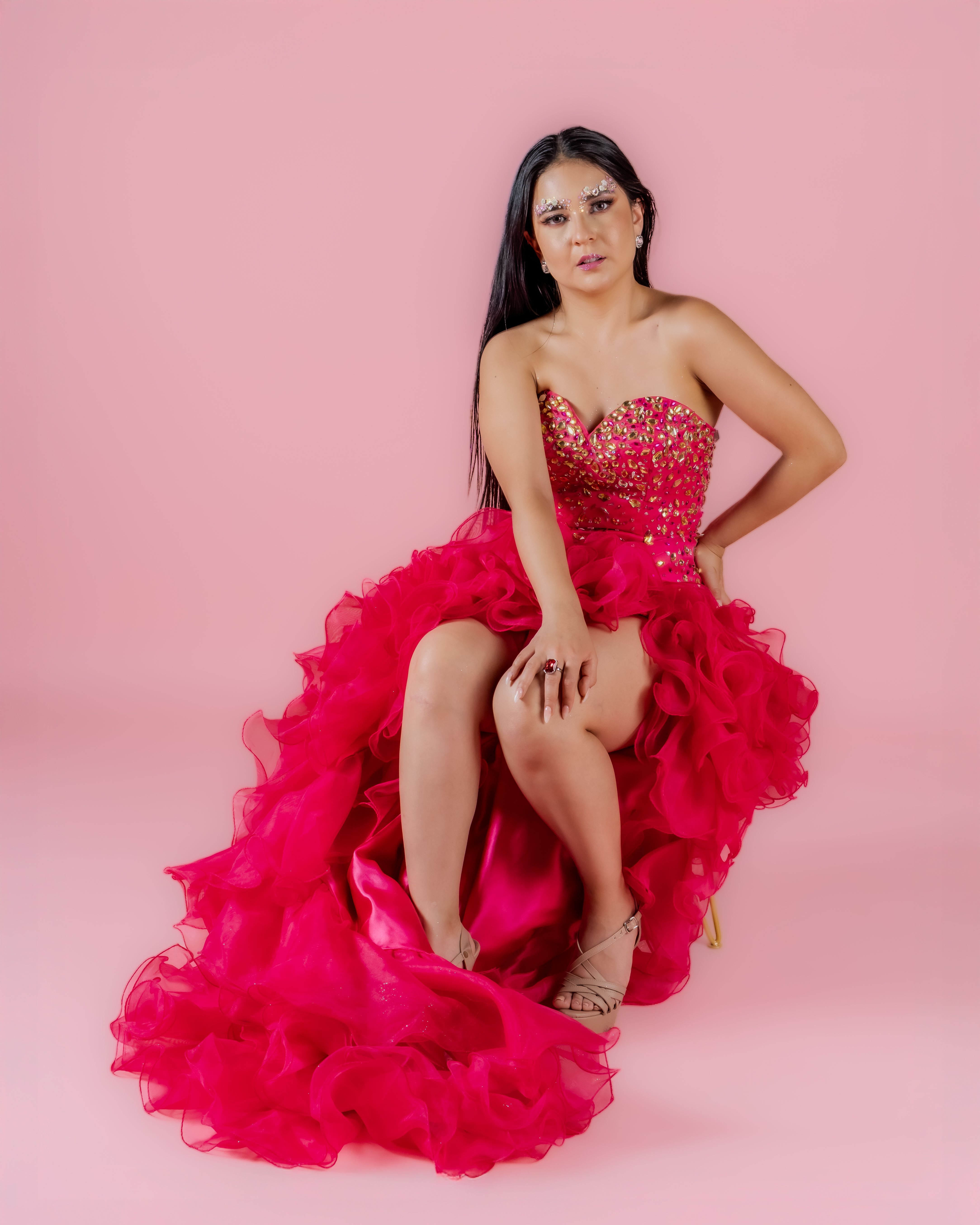 Elegant Woman in Vibrant Pink Gown on Pink Background