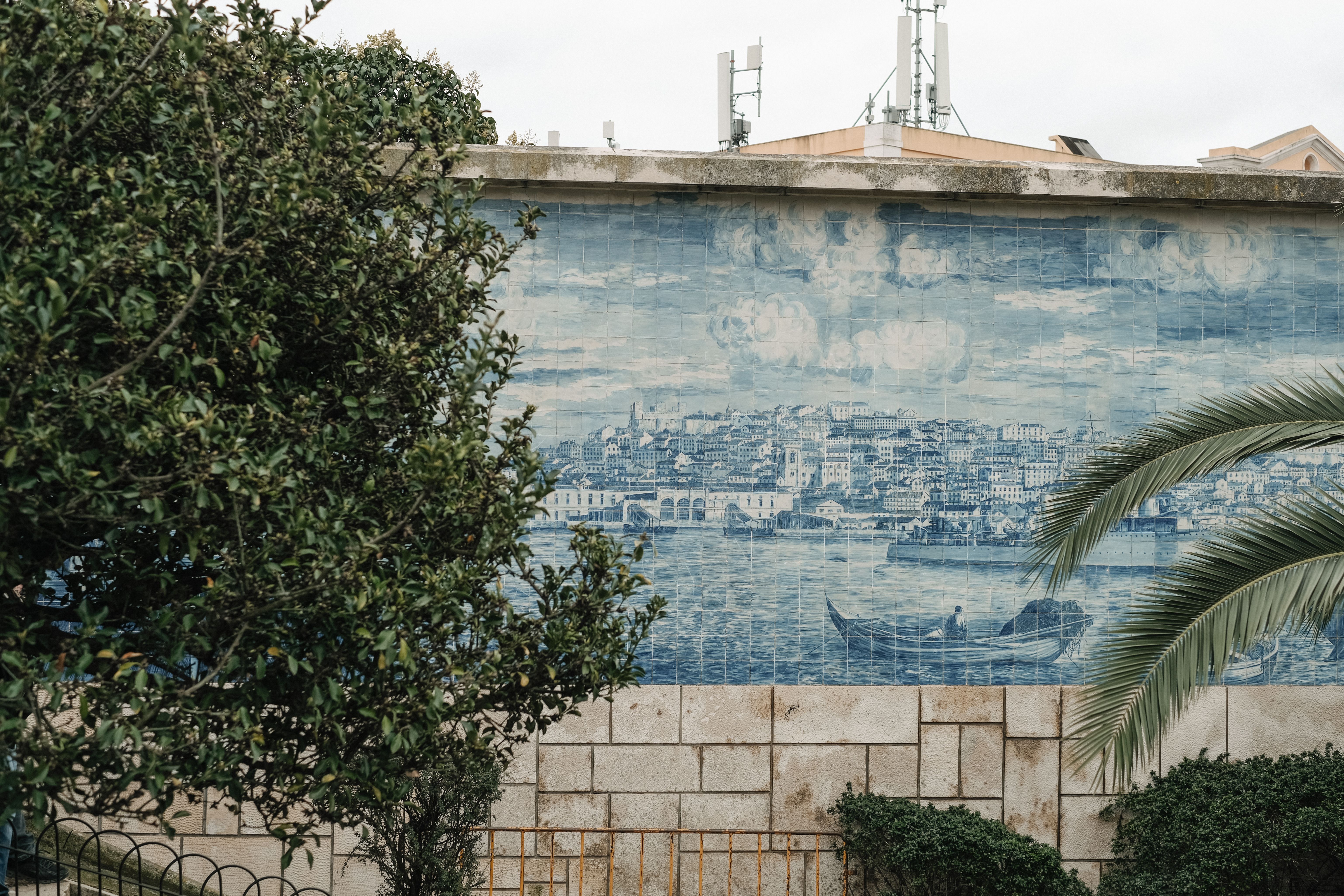 Steep tiled steps in Mouraria with a fado mural on the wall