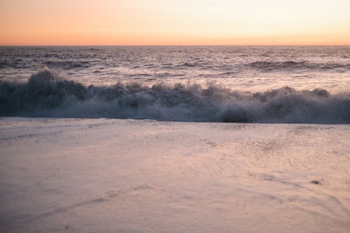 Waves breaking on a beach at sunset — Alina Chernii on Pexels