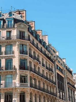 Elegant Parisian buildings with French architecture against a clear blue sky.