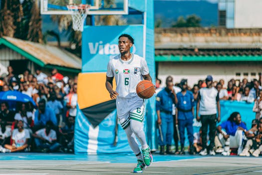 Basketball player dribbles outdoors during a vibrant community game.