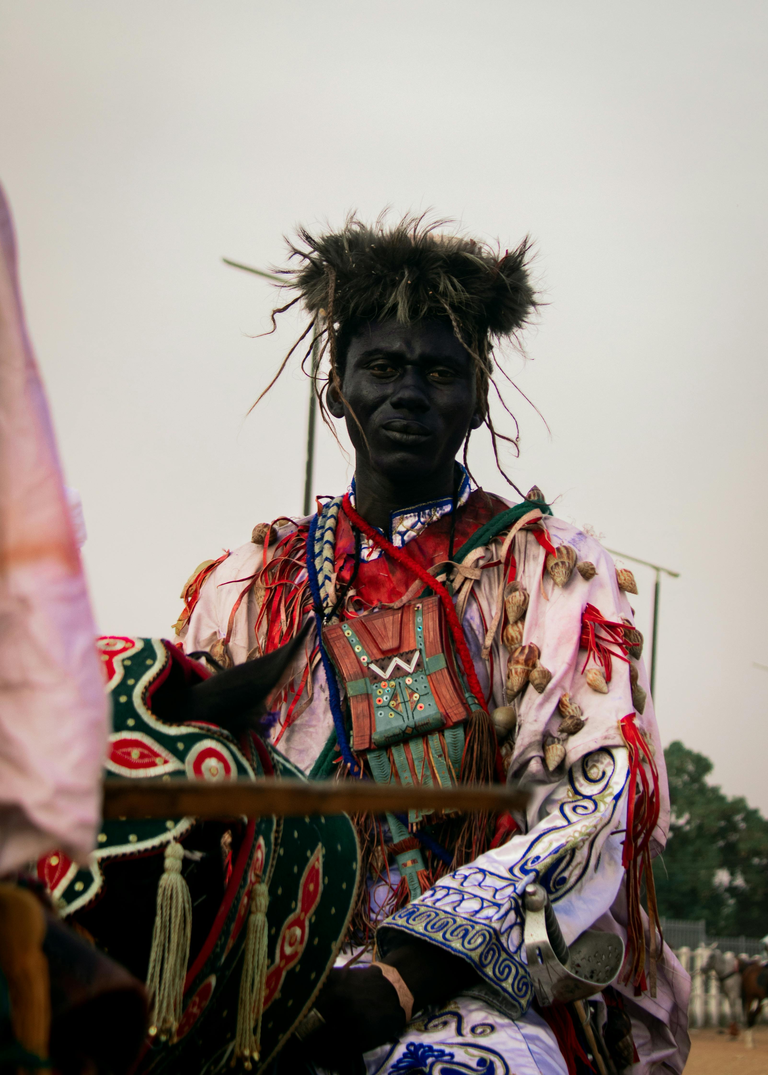 A Nigerian horseman in vibrant cultural attire represents northern Nigeria's rich heritage.