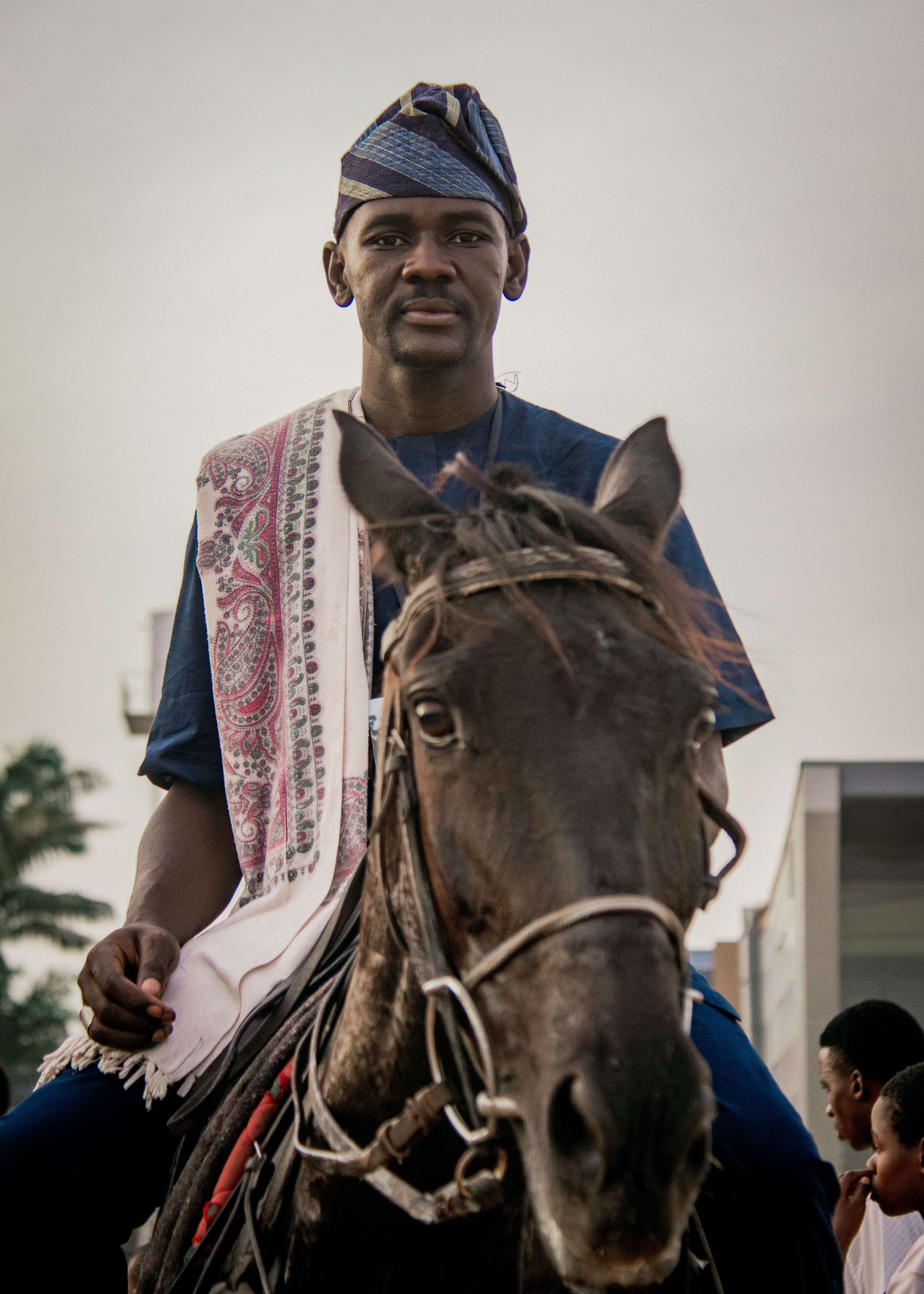 A man in Nigerian attire riding a horse, showcasing African culture.