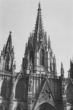 Detailed view of the Gothic spires of Barcelona Cathedral in black and white.