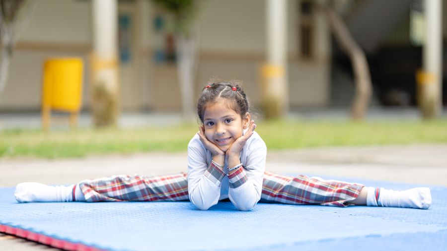 Students practising yoga at sunrise in the school courtyard