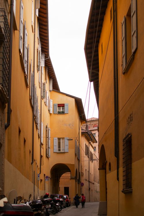 Free Explore the picturesque narrow streets of Bologna with its iconic warm-toned buildings and classic architecture. Stock Photo