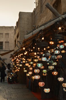Beautifully lit traditional lanterns at a bustling Dubai market during dusk, capturing the city's vibrant essence.