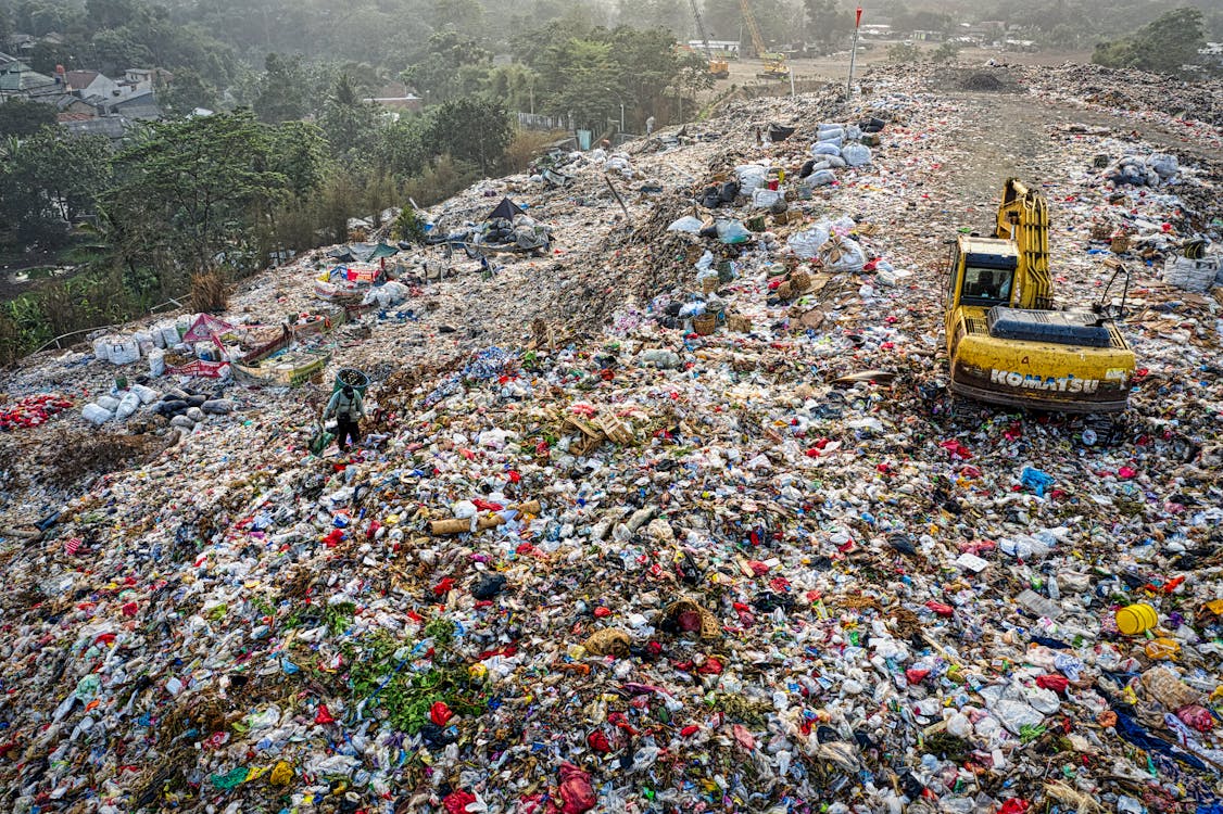 Yellow Excavator in Garbage Mountain