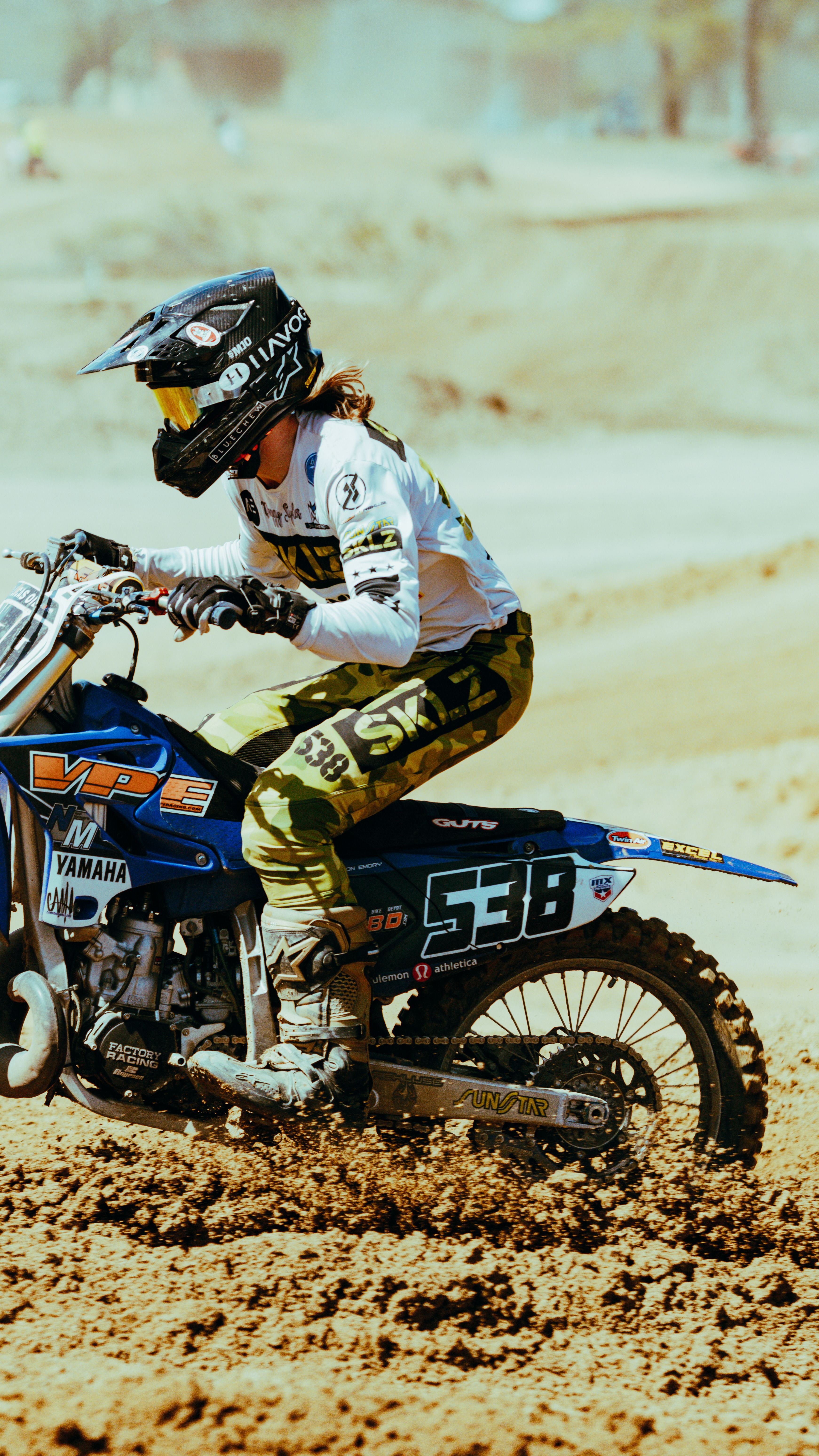 Rider in action on a dirt bike, showcasing adrenaline and speed on a rugged track.