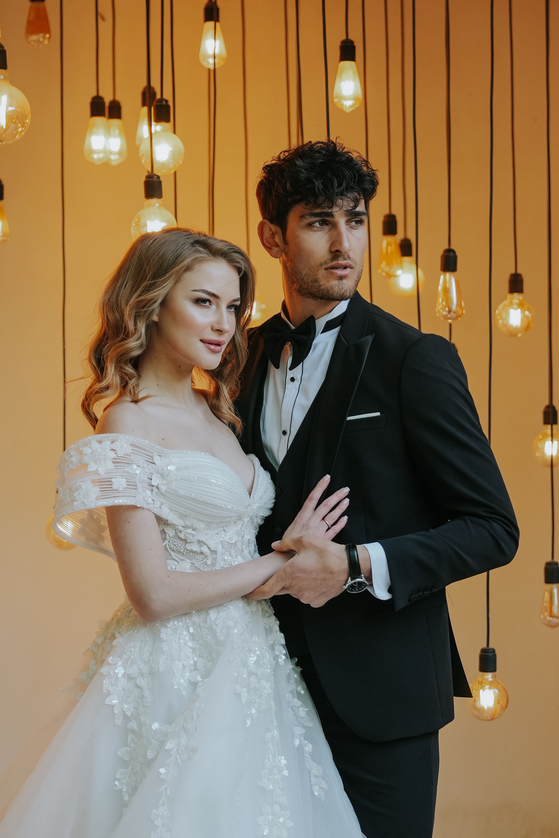 An elegant couple beneath a crystal chandelier