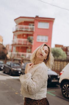A young woman enjoying a sunny day in an urban neighborhood.