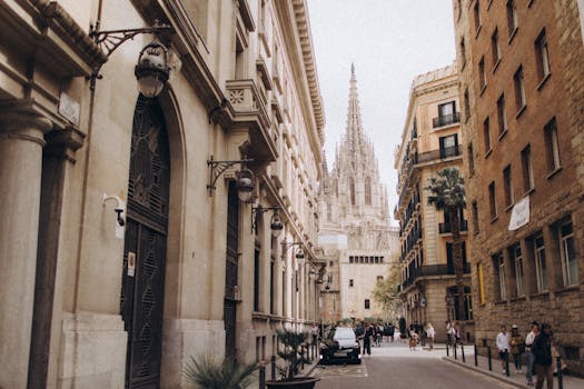 View of the iconic Gothic Cathedral in Barcelona surrounded by classic architecture and street life.