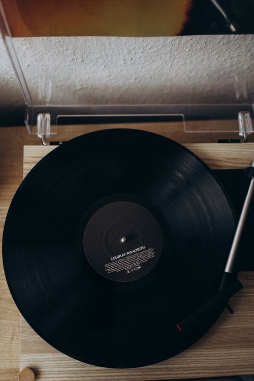 Free Top view of a vinyl record spinning on a classic player indoors, capturing retro music vibes. Stock Photo