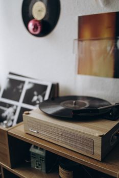 A serene setup featuring a wooden turntable playing vinyl records against a stylish backdrop.